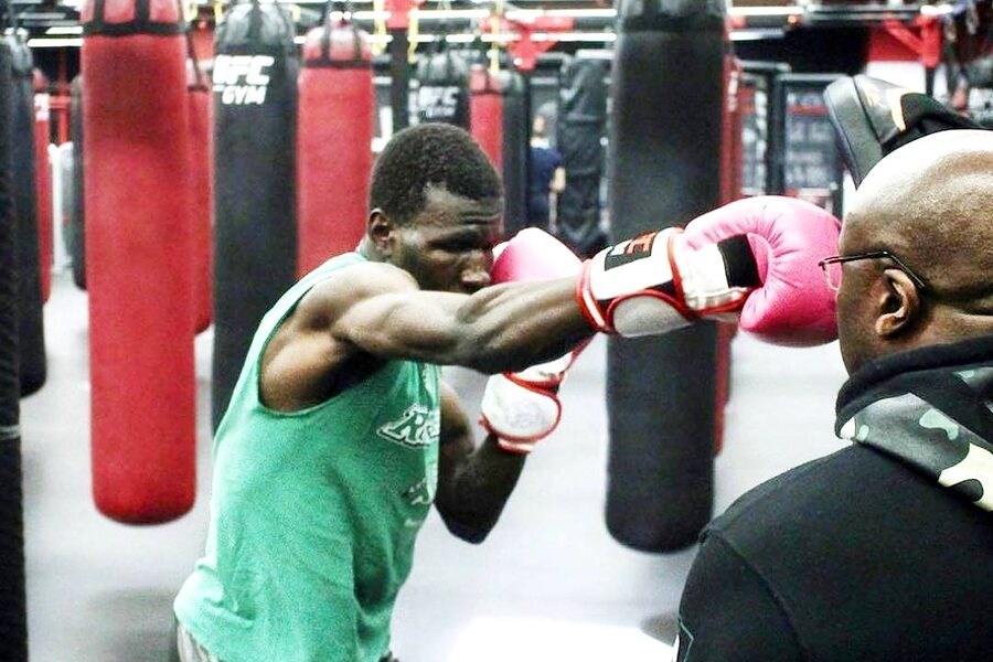 A client working combinations on the mitts with Yves
