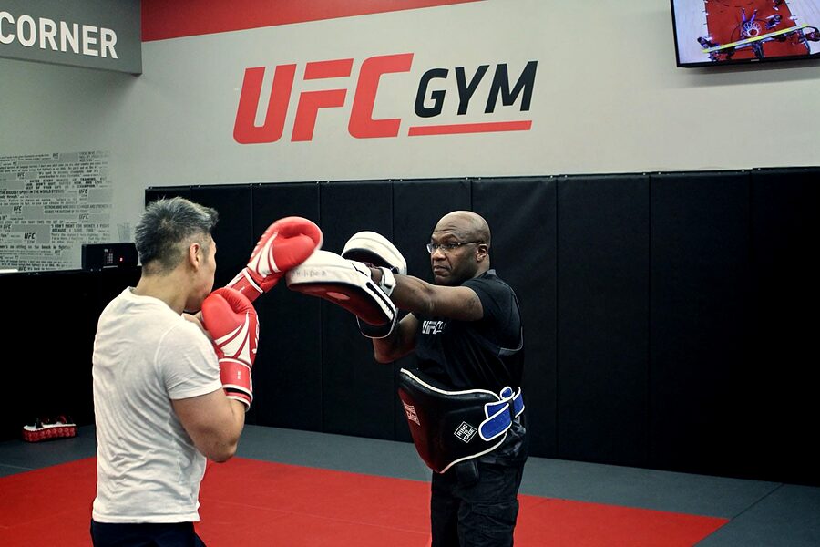 Pad work on the mat at UFC Gym